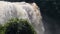 A view of huge splash and strong flow of an incredible waterfall in the jungle.