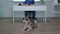 View of husky lying on the floor and vet sitting at a table and writing