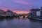 View of the iconic Ponte Vecchio over the Arno River at dusk in Florence, Italy