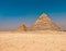 View of the iconic Pyramids of Giza in Cairo, Egypt, framed against the backdrop of desert landscape