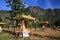 View on idyllic secluded valley with countless sitting buddha statues against Mountain face and blue sky