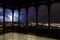 View of illuminated city during thunderstorm with lightning from wooden openwork gallery or gazebo in Prague, Czech Republic