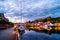 View of the illuminated houses and yachts with Fredriksted fortress at the background in Halden, Norway