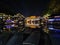 View of illuminated at night riverside houses in ancient town of Fenghuang known as Phoenix