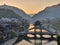 View of illuminated at night riverside houses in ancient town of Fenghuang known as Phoenix