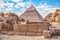 View of the incredibly majestic pyramid of the cheops on a sunny day in the desert with ancient ruins