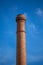 View of a industrial chimney made with orange massive brick