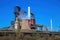 View on industrial complex with smoking chimneys and tower against blue sky - Thyssen Krupp steel company