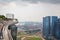 View of infinity pool at top of Marina Bay Sands Hotel with port cranes and shipping containers in background in Singapore