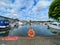 View on inland port with boats in summer with orange lifebelt, sealife building background