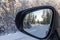 View inside mirror on beautiful winter landscape. Transportation concept.