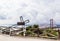 View of Installation with a fallen metal cross near Christ the King statue in Lisbon, Portugal