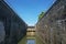 View of interior of ship lock on side of small hydroelectric power station, flood gate at the end