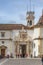 View of a iron gate of the University of Coimbra, classic architectural structure with masonry, with people, tower of the