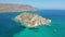 View of the island of Spinalonga with calm sea.