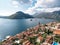 View of the islands in the Bay of Kotor over the red roofs of old houses. Perast, Montenegro. Drone