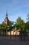 View of Itzehoe cityscape in summer with St. Laurentii church clock tower and blue sunset sky background. Bus stop in foreground