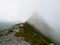 View on jagged mountain of Zillertal alps on a foggy summer day