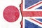 View of Japan and UK national flags on cracked concrete wall background