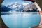 View of Johns Hopkins Glacier through a ship port hole/window