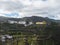 View of Juncalillo small village with chuch in rural landscape with green hills, and terraced fields winding roads. Gran