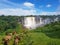 View of the Kalandula waterfalls on Lucala river, Donkeys grazing in a field of herbs