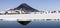 View of the Karymskaya Sopka and the reflection of the volcano cone in the lake water