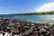 View of kealakekua bay on Hawaii`s Big Island; blue-green water, coastline with green plants in background.