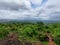 View of Kerala tourist destination meadows green plants under the rain cloudy sky from Posadi Gumpe hill station