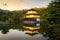 View of Kinkakuji the famous Golden Pavilion with Japanese garden and pond with dramatic evening sky in autumn season at Kyoto,