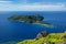 View of Kuata Island from Wayaseva Island with a hiker standing on a rock, Yasawas, Fiji