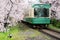 View of Kyoto local train traveling on rail tracks with flourish