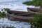 View of lake, aquatic vegetation and old wooden fishing boats on the banks