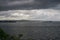 View of lake of bolsena under a cloudy gray sky