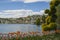 View of the lake and the city of Lugano, Switzerland on a sunny summer day.Beautiful city landscape, red blooming tulips.