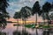 View on the lake fishing harbor with boats parked on the shore during sunset.