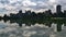 View of lake Lost Lagoon in Stanley Park, Vancouver, Canada with the skyline of district Westend reflected in the water.