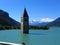 View of the lake Resia. perfect blue sky over the azure water in lake. Bell tower of the Reschensee South Tyrol, Italy