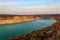 View of lake with sandy shores in flooded sand quarry