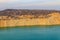 View of lake with sandy shores in flooded sand quarry
