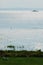 View from the lakeshore with deck chair on big lake with ship in the distance