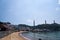 View of Lamma Island beachline with boats in the sea and Lamma Power Station