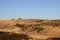 View of a landfill or dump, with bulldozer machinery stacking waste and garbage