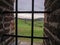 A view of the landscape through the barred window