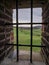 A view of the landscape through the barred window