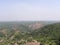 View of landscape below and skyline, trees and forest from top of mountain