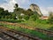 View landscape farmland and paddy rice field in farm of countryside rural with track railway train and Phu Khao Ok Thalu mountain