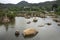 View landscape with stone and rock water garden of Tiantan temple and chedi in Tian Tan Garden with meadow and mountain