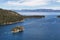 View of Large Bay and Lake with Boats, Small Island, Trees and Mountains.