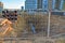 View on large construction site with and buildings on sunset background. Concrete sewer pipes for laying an external sewage system